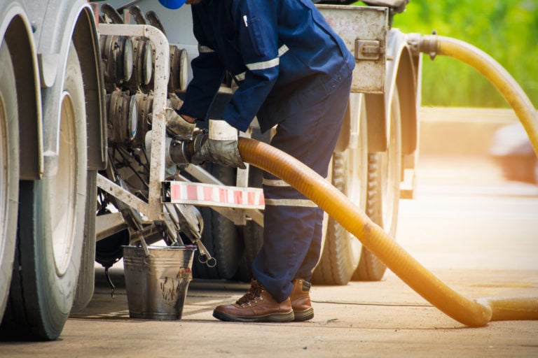 Eco Tank Services technician refueling a freight truck using eco-efficient fuel management equipment