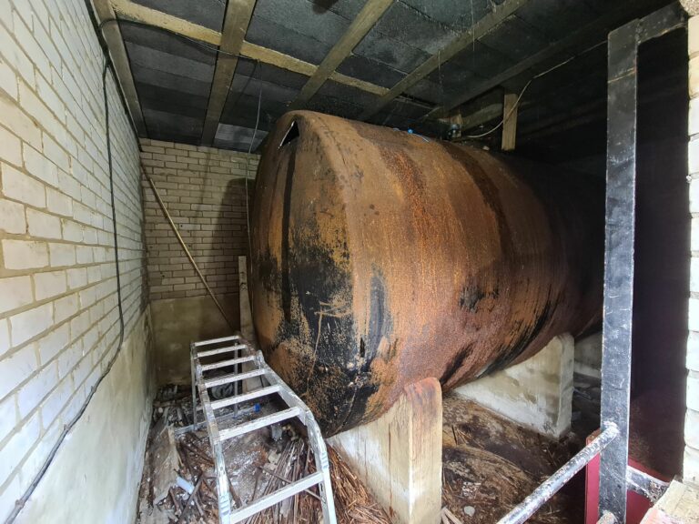 13,000-litre metal tank undergoing professional decommissioning for a council project.