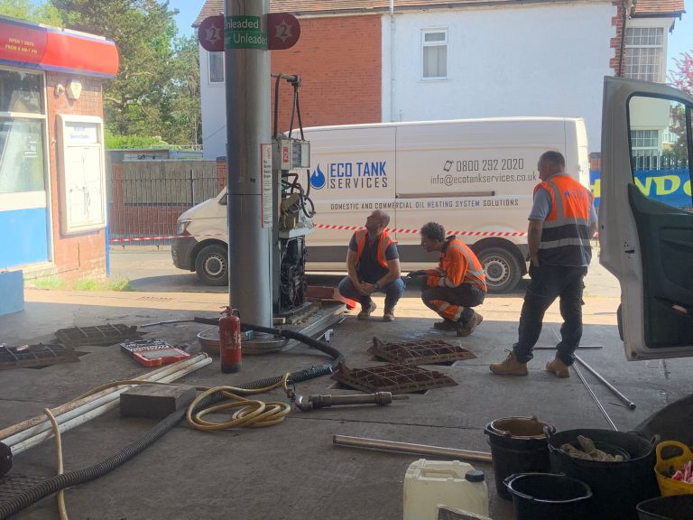 Team conducting commercial petrol station decommissioning and fuel tank removal on site.