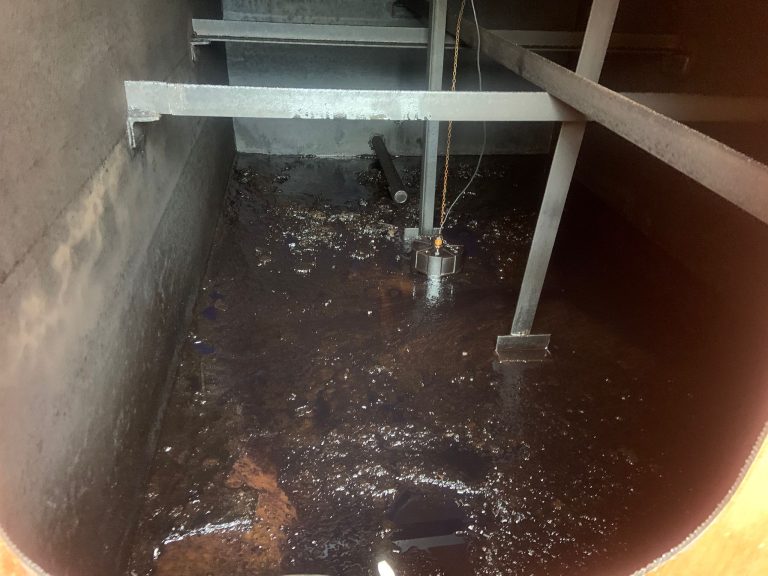 Cleaning process inside a metal storage tank.
