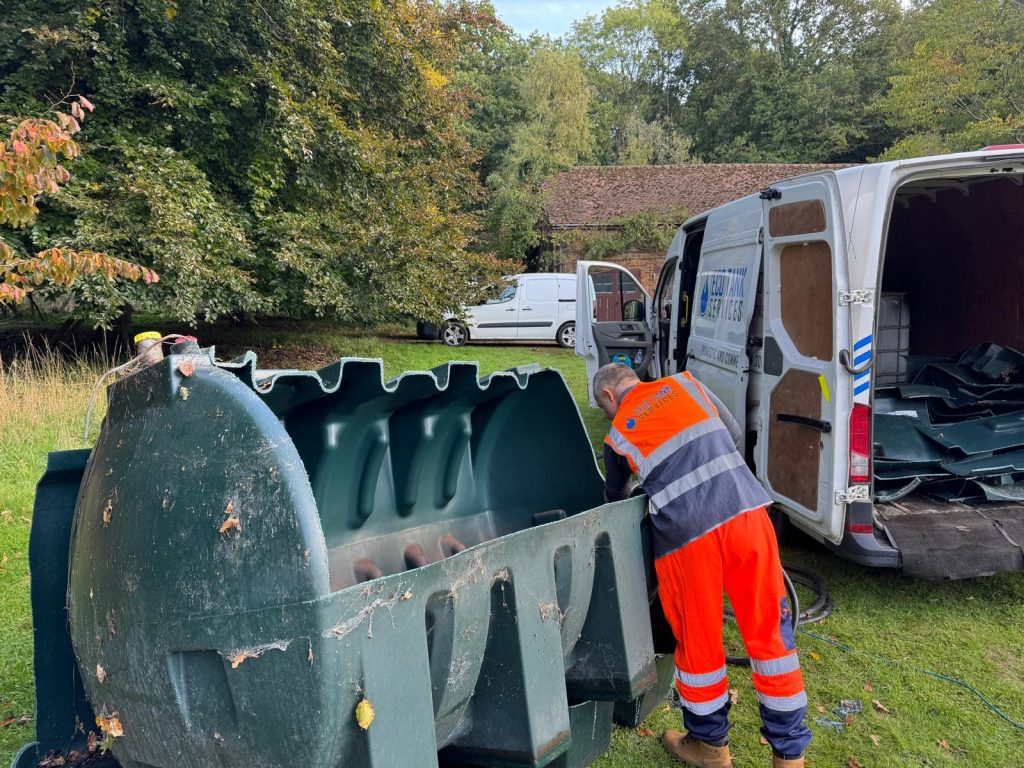 Ecotank Services engineer removing an old oil storage tank safely from a residential property.